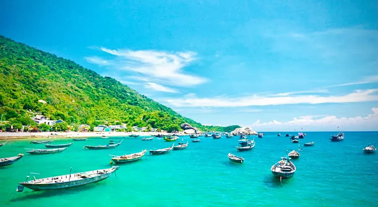 Emerald sea and small boats create a stunning picture.