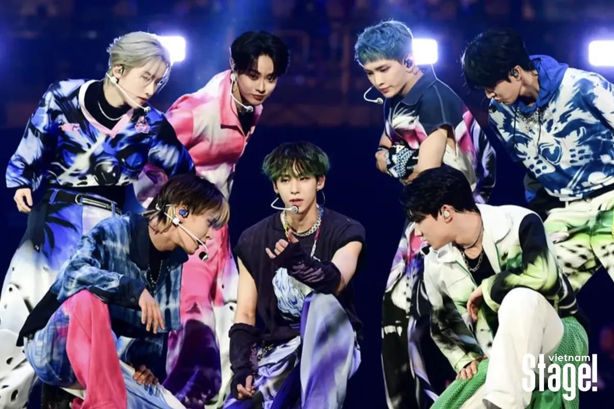 K-pop group performing on a vibrant stage at a major music event.