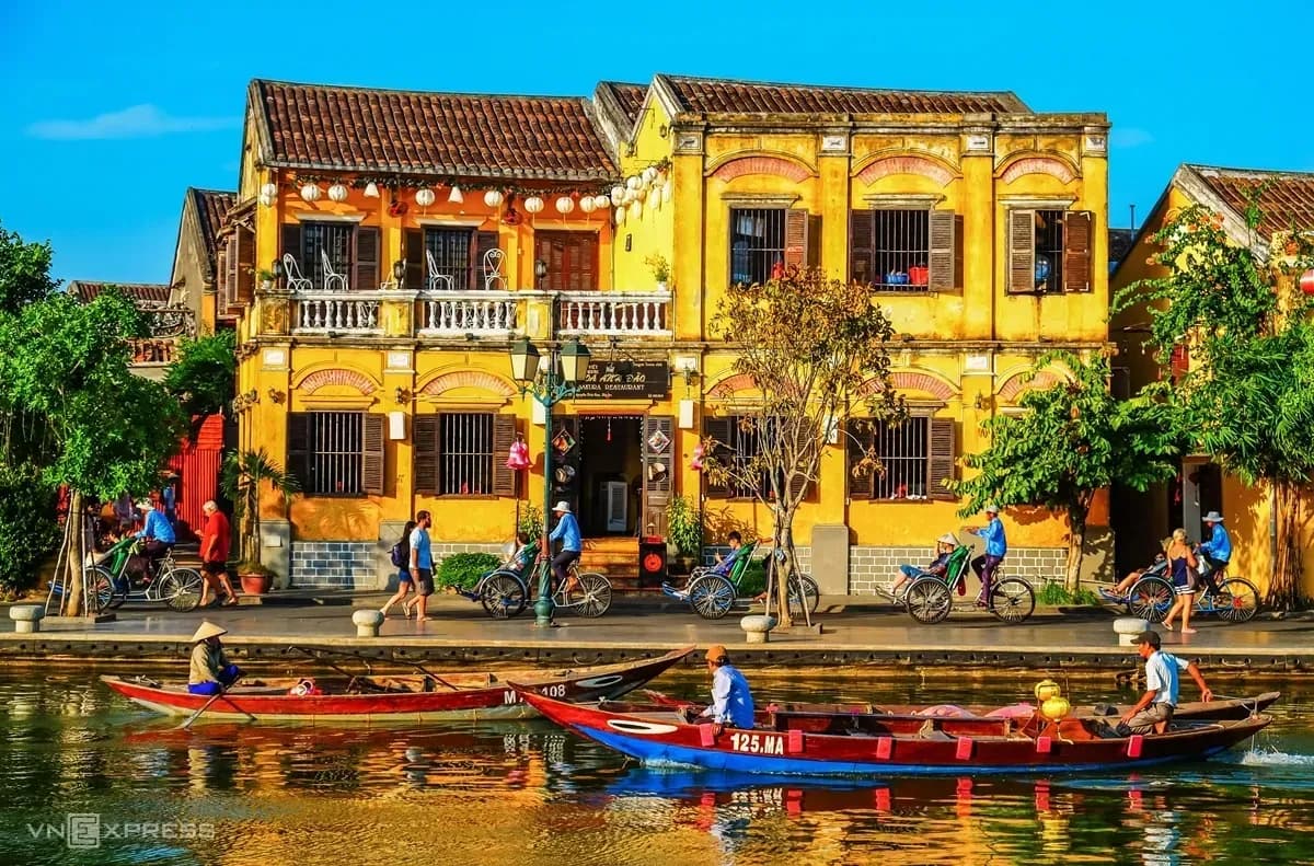 A beautiful ancient house by the river in Hoi An, embracing cultural charm with brown tiled roofs and hanging lanterns.