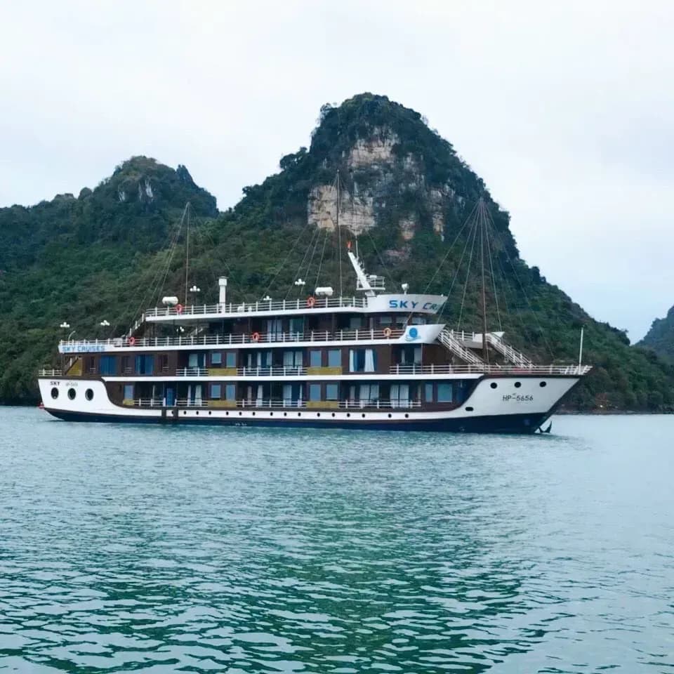 Sky Cruises cruise on the turquoise waters with mountains in Lan Ha Bay