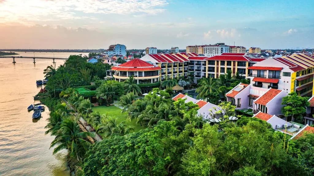 Luxurious riverside resort in Hoi An, blending nature with sophisticated architecture.