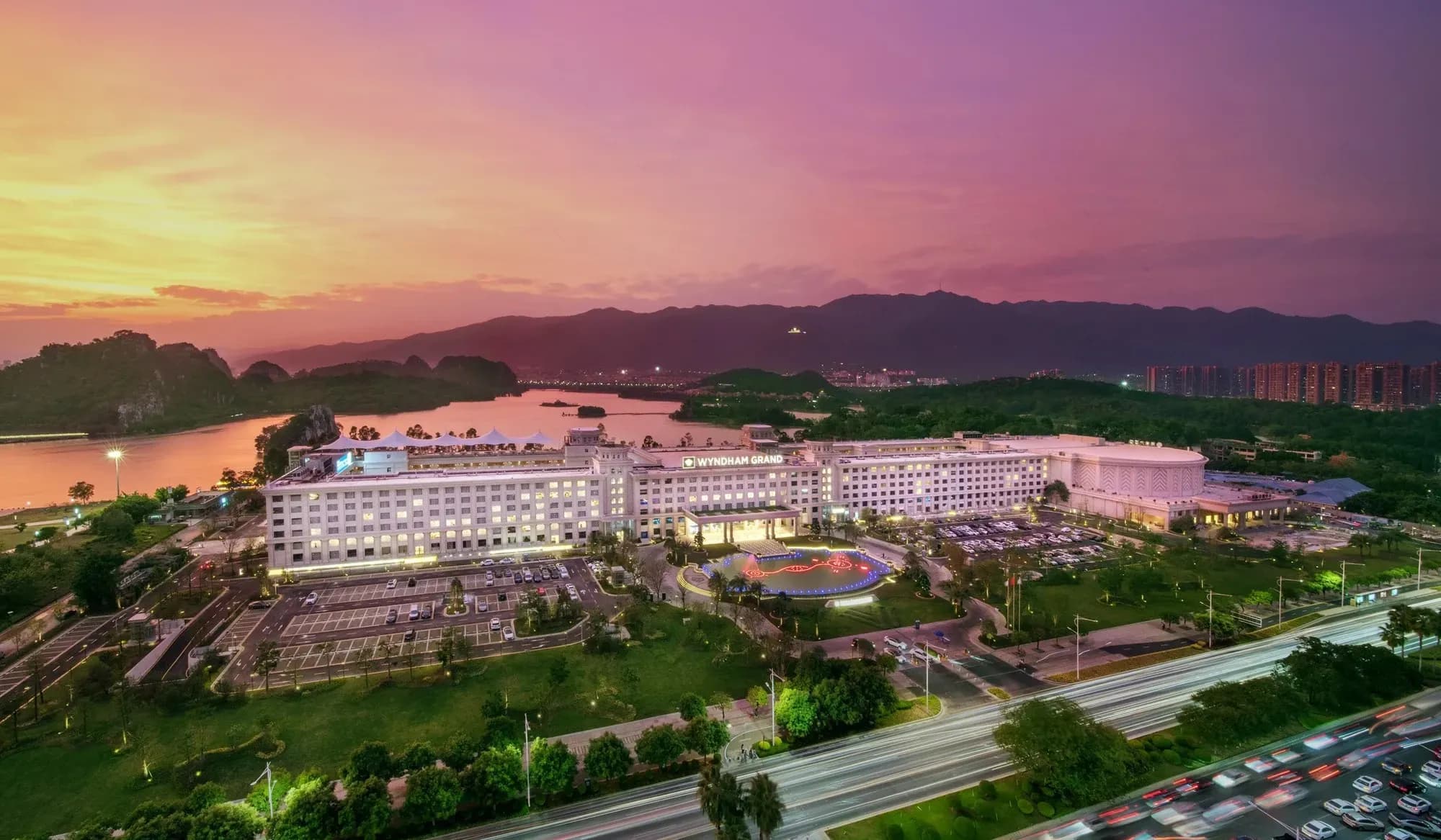 Luxurious hotel scene by the seaside at sunset.