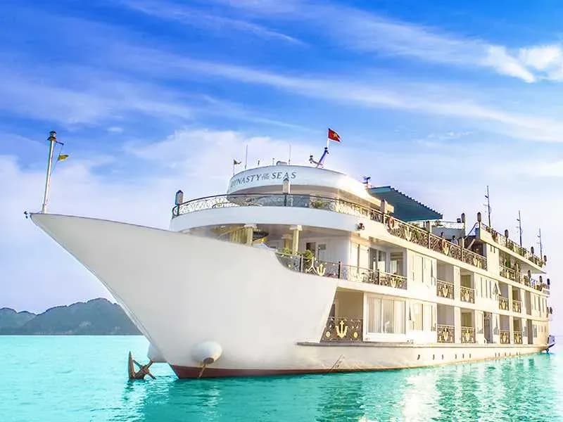 Luxurious Dynasty Of The Seas cruise glistening on the turquoise waters of Ha Long Bay.