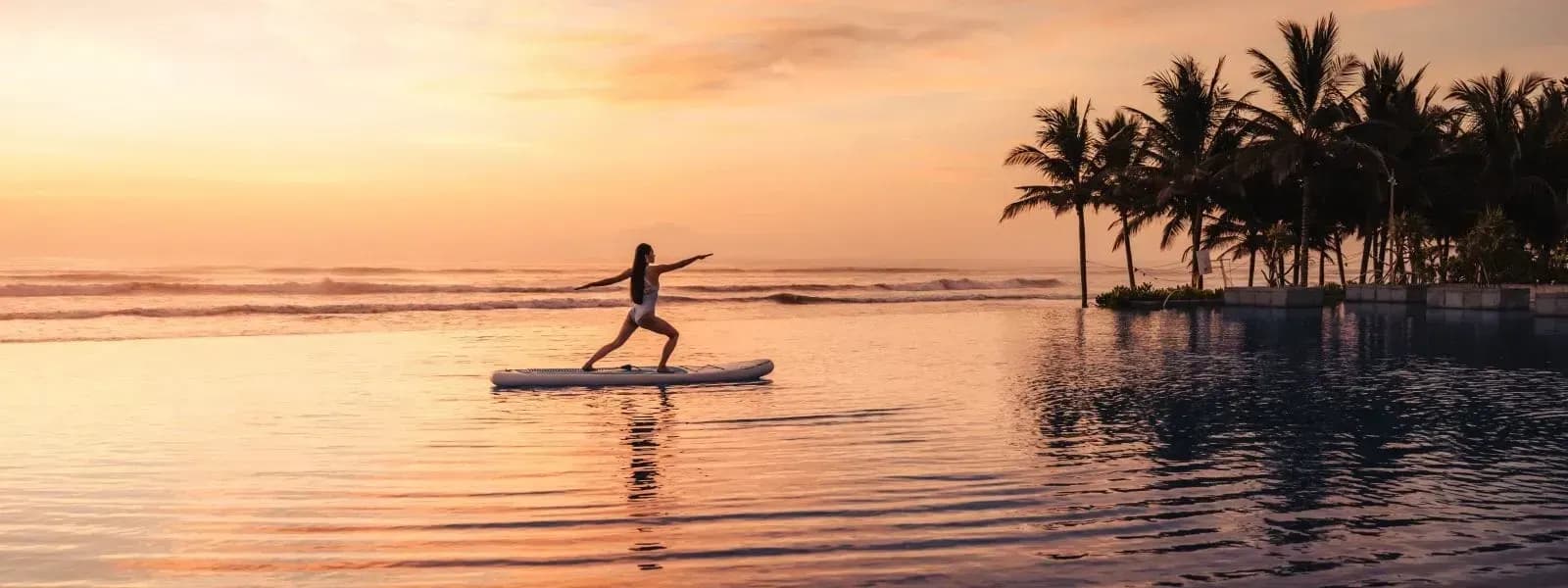 Yoga by the infinity pool under a stunning sunset.