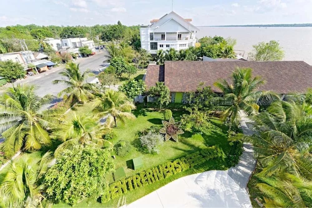 Lush and serene surroundings of Forever Green Resort by the Tien River.